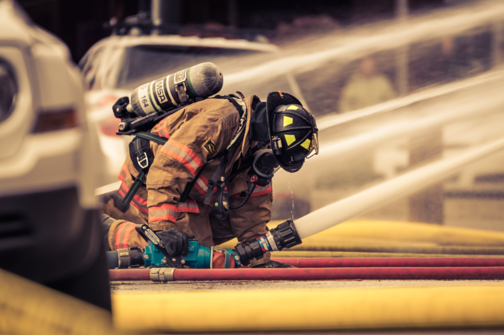 a firefighter holding a hose of water